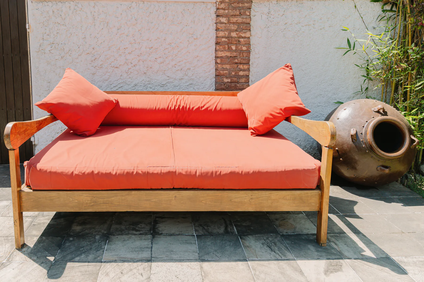 A day bed in the poolside garden